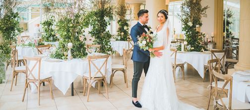 Bride and Groom in conservatory set up for wedding 