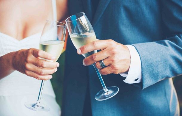Birde and Groom holding Champagne glasses