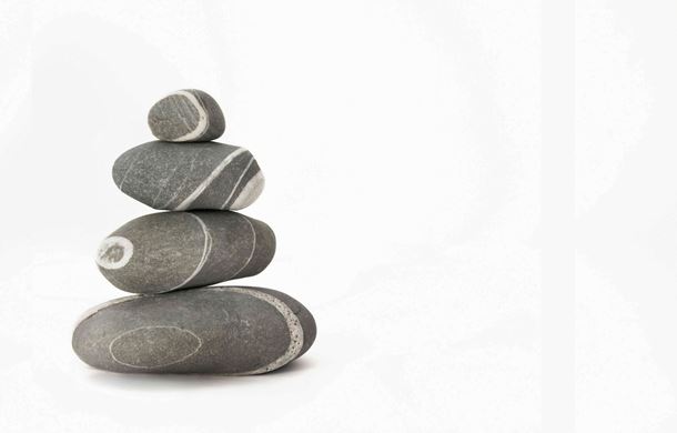 Pebbles stacked on white background
