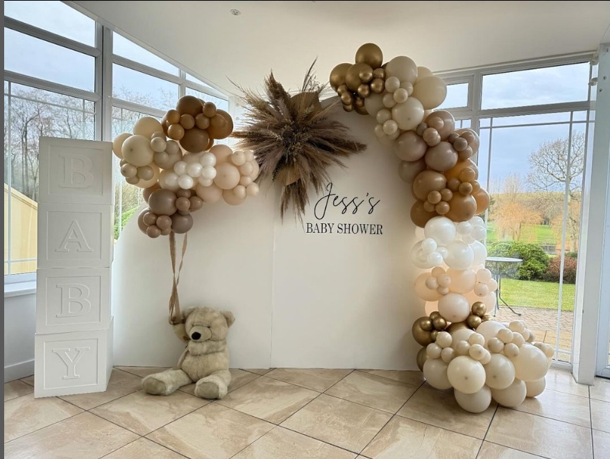 Balloon arch and boxes spelling 