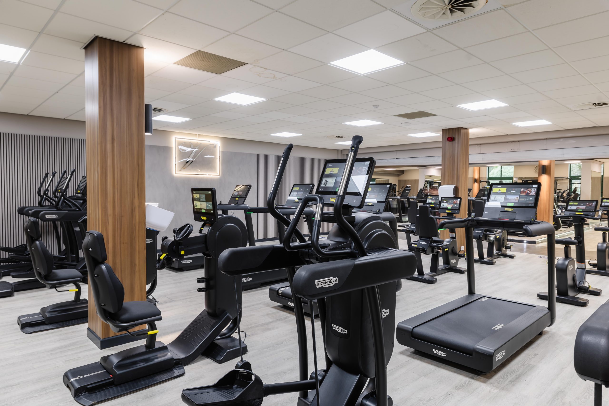 A modern Vale Resort South Wales Gym interior, newly refurbished with cardio and strength machines under bright lights.